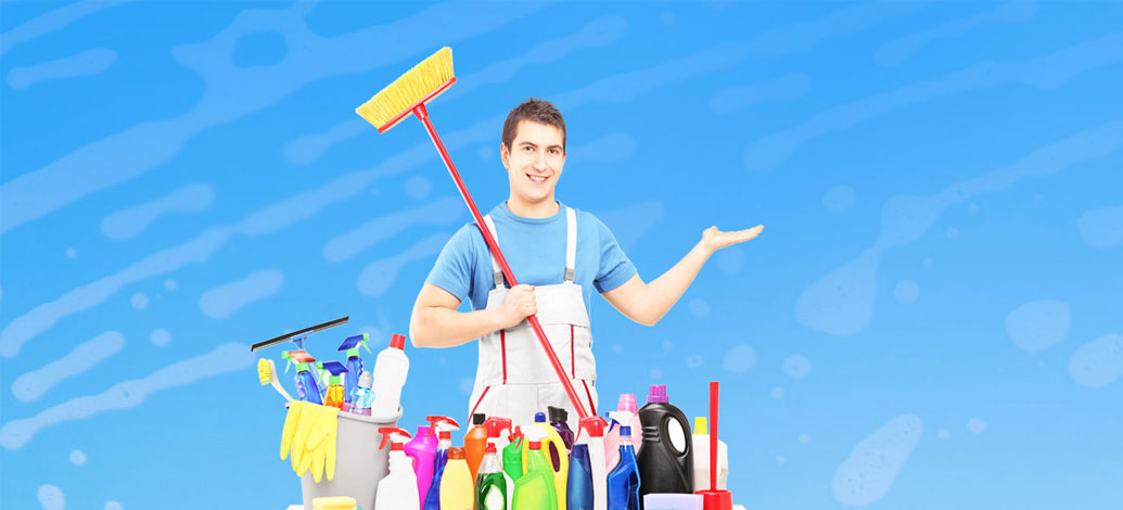 Smiling male cleaner with cleaning equipment and mop